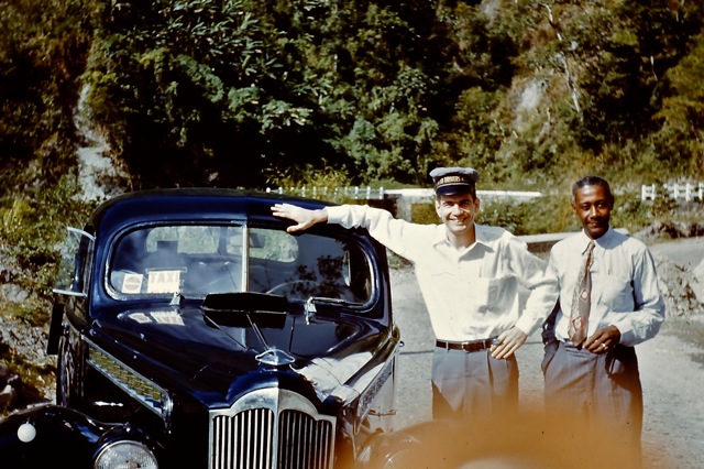 1955 February Lt (JG) Merrill and island tour driver in Jamaica - overheated Packard.jpg